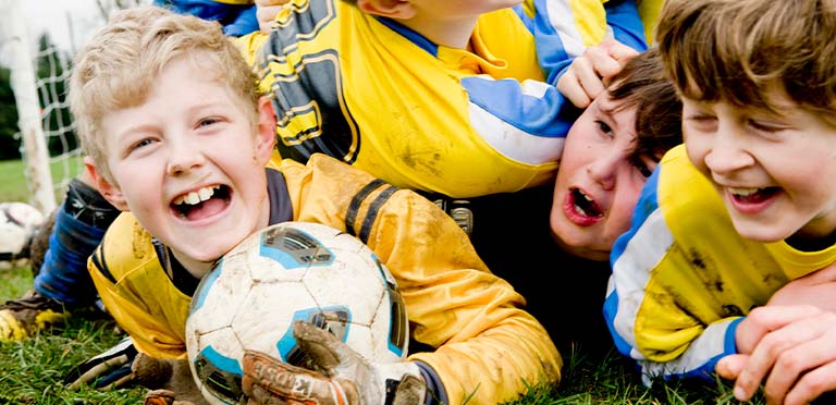 Equipo de fútbol ríe y se divierte practicando un deporte para niños que disfrutan 